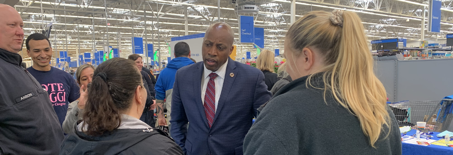 commissioner harrison talking with people inside a store
