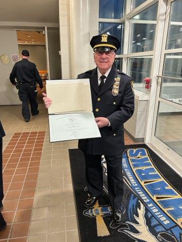 police officer posing with an award