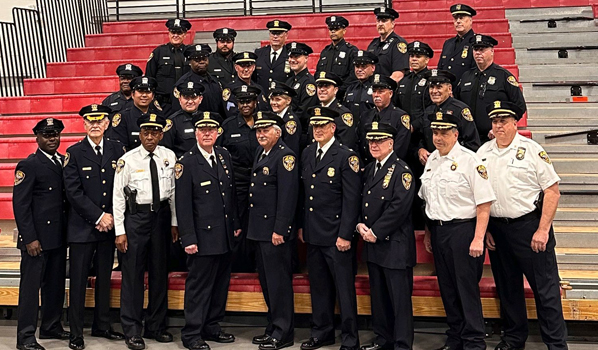 a group of police officers sitting on bleachers